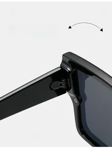 Detailed macro view of durable metal hinges on trendy black oversized square sunglasses