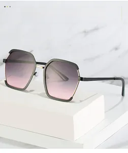 Close-up of geometric square sunglasses with gradient purple lenses and gold metal details