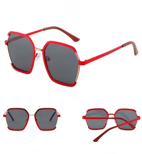 Detailed views of red polygonal sunglasses with metal temples and gradient lenses