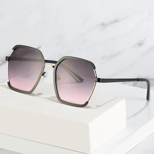Modern geometric metal sunglasses with gradient lenses on white marble background