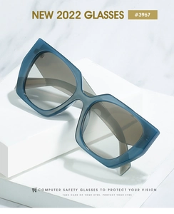 Detail of square Morandi blue frame glasses with light grey lenses on marble background