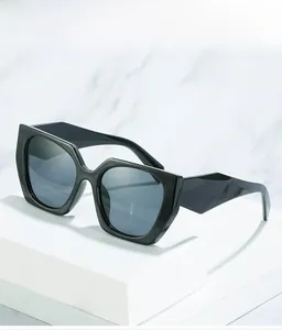 Detailed shot of retro oversized square black sunglasses with wide temples on marble background
