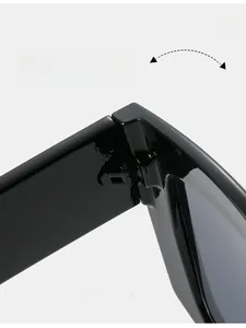 Close-up of durable metal reinforced hinge on black oversized square sunglasses