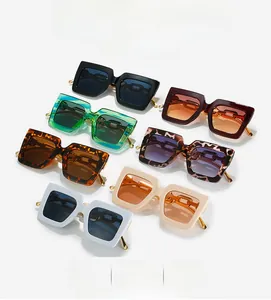 Detail view of square frame sunglasses in seven colors with metal chain temple design