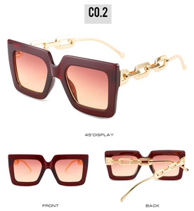 Detail view of burgundy square sunglasses with unique gold chain-link metal temples