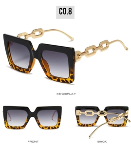 Detail of square sunglasses with leopard print accents and gold chain-link arms