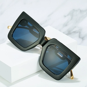 Fashionable oversized square sunglasses with matte black frames and golden metal temples