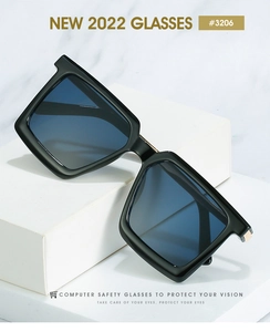 Detail of square black frame sunglasses with blue light coating lenses on display
