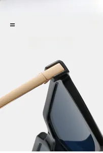 Close-up of premium black frame sunglasses with golden metal hinges and temples