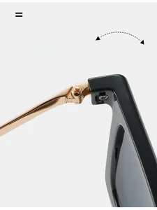 Close-up of durable golden metal hinges and black frame on stylish square sunglasses
