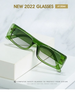 Detail view of green rectangular acetate frame with grey lenses on marble display