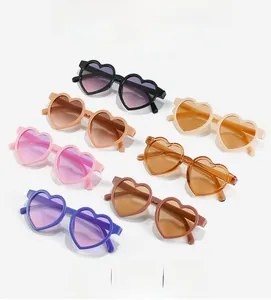 Multiple colorful heart-shaped sunglasses for kids with UV protection in various trendy hues