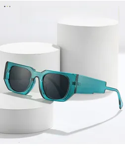 Detail of teal translucent retro square sunglasses on a white minimalist pedestal
