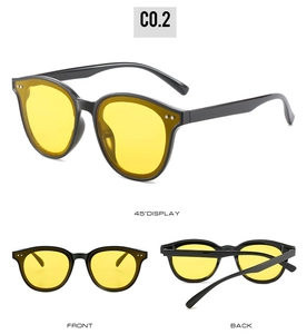Detailansicht der Retro-Rundsonnenbrille mit gelben Gläsern und schwarzem Rahmen.