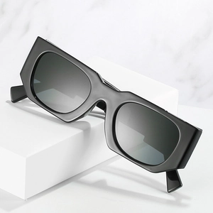 Retro square thick frame sunglasses with dark grey lenses on white geometric block