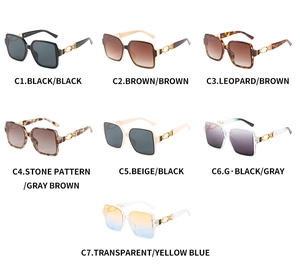 Flat lay of retro square sunglasses collection in seven colors with metal hinge details