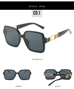 Detail view of square black sunglasses with gold metal chain temple design and grey lenses
