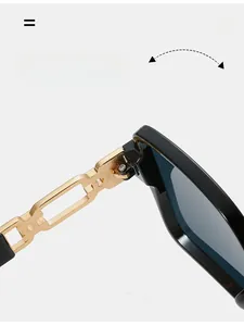 Close-up of durable golden metal chain hinge and black temple of vintage sunglasses