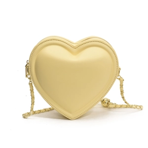 Cream heart-shaped crossbody bag with gold chain strap and decorative metal ball charm