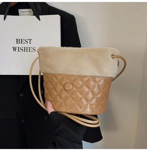 Detail of plush faux fur trim and quilted diamond pattern on khaki bucket bag