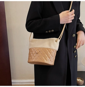 Detail of vintage quilted leather and plush faux fur bucket bag with thin shoulder strap