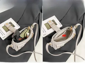 Internal view of the rivet shoulder bag showing space for phone and makeup