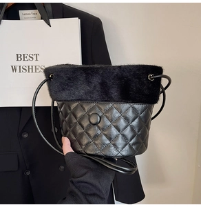 Detail of quilted black leather texture and thick faux fur trim on bucket bag