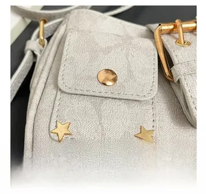 Detail showing high-quality twill fabric texture and gold star studs on the shoulder bag