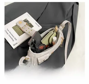 Internal view of denim shoulder bag showing space for phone, wallet and accessories