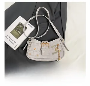 Detail showing grey Y2K star rivet motorcycle bag with multiple zippers and buckles