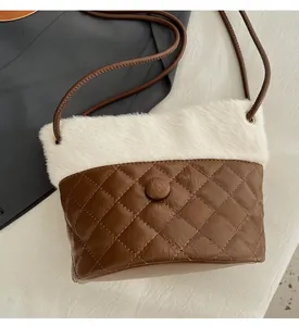 Macro detail of quilted brown leather and white faux fur texture on a bucket bag