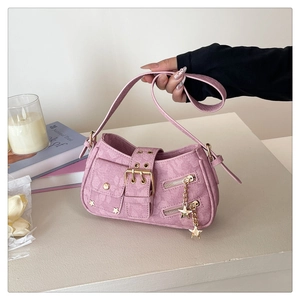 Close-up of pink jacquard bag featuring star charms and floral embossed patterns