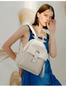 Detail of off-white lychee texture leather backpack with stylish ring buckle closure