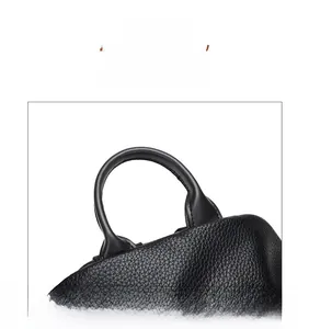 Close-up of litchi pattern leather handle on black large capacity backpack