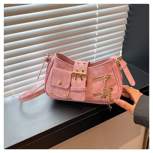 Detail of pink Y2K denim bag with star studs and metallic buckle close-up view