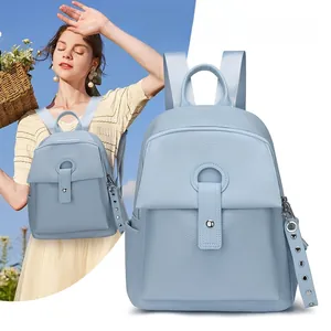 Detail view of light blue lychee pattern leather backpack with stylish ring buckle closure