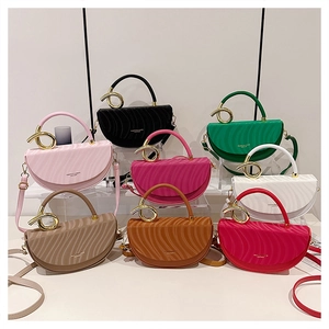 Close-up of eight textured saddle bags with golden circular ring hardware details
