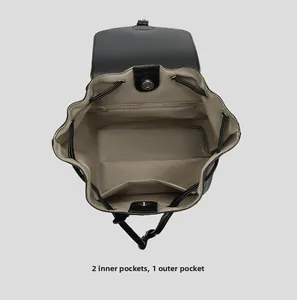 Detailed interior view of a retro black backpack showing pockets and brown lining