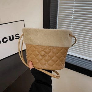 Quilted camel leather bucket bag with beige plush trim and slender shoulder strap