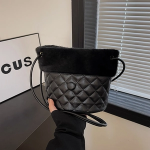 Quilted black bucket bag with plush faux fur trim and adjustable crossbody strap