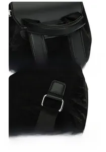 Detail showing ergonomic top handle and durable silver metal D-rings on black backpack
