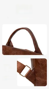 Detail of dark brown pebble leather bag with gold hardware and reinforced stitching