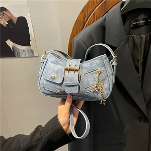 Y2K style light blue denim underarm bag with gold star studs and metal buckle detail