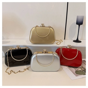 Detailed view of glossy evening clutch bags with diamond clasp and gold chain in four colors