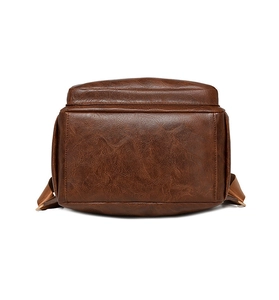 Detailed bottom view of vintage brown leather backpack showing stitching and texture