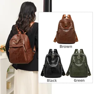 Detail view of vintage oil wax leather backpacks in brown, black, and green options