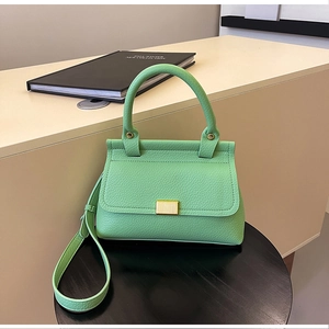 Dettaglio della borsa verde menta in pelle con trama litchi e fibbia dorata rettangolare