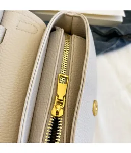 Dettaglio della cerniera dorata di qualità e pelle martellata sulla borsa beige