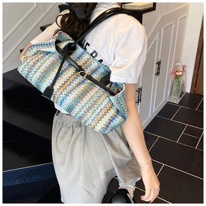 Detail of multi-color woven pattern on tote bag with adjustable black leather strap