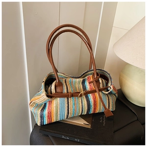 Close-up of colorful vertical stripe woven tote bag with brown faux leather handles